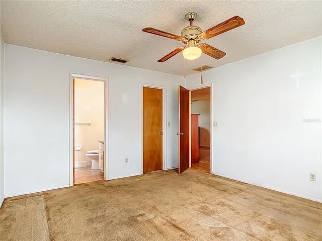 a view of a livingroom with a ceiling fan and window