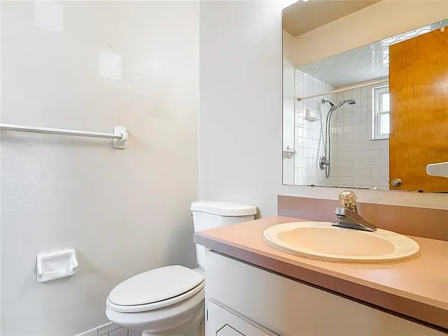 a bathroom with a sink a toilet and a mirror