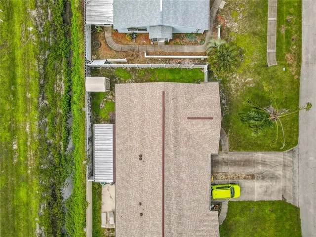 a aerial view of a house with a backyard