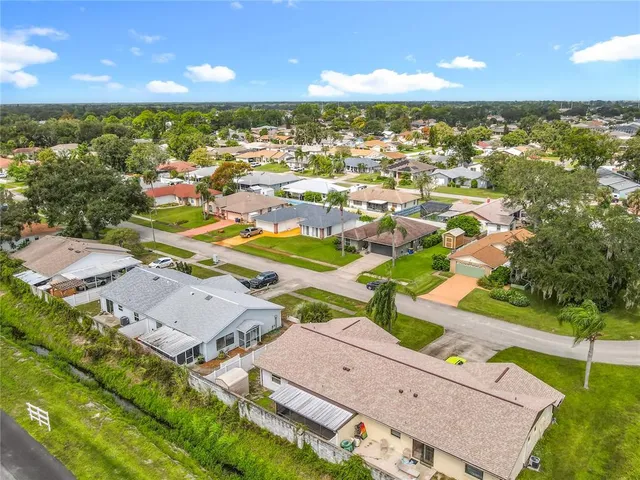 an aerial view of residential houses with outdoor space and swimming pool