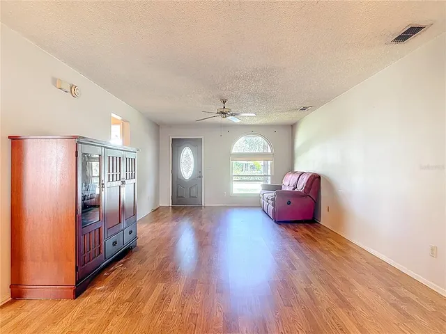 a spacious bedroom with a bed and windows