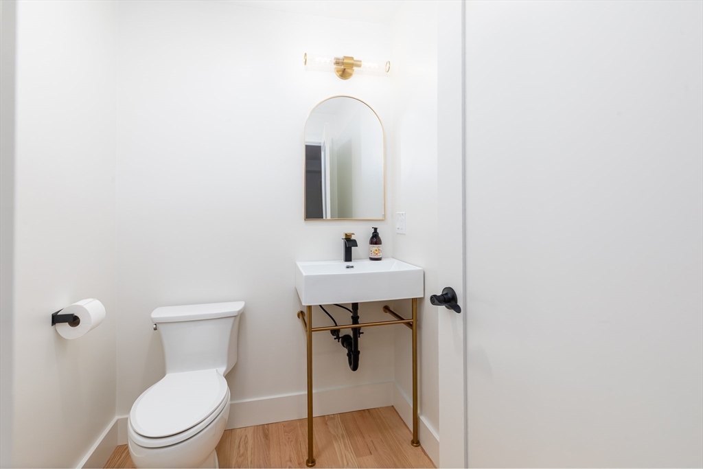 96 Burpee Road, Unit 1 Swampscott, MA 01907 - Photo 14 of 17 a bathroom with a sink toilet and a mirror