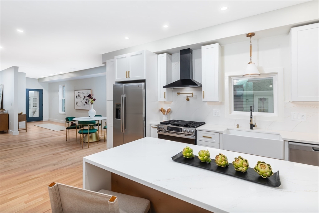 96 Burpee Road, Unit 1 Swampscott, MA 01907 - Photo 6 of 17 a kitchen with stainless steel appliances granite countertop a sink refrigerator and cabinets