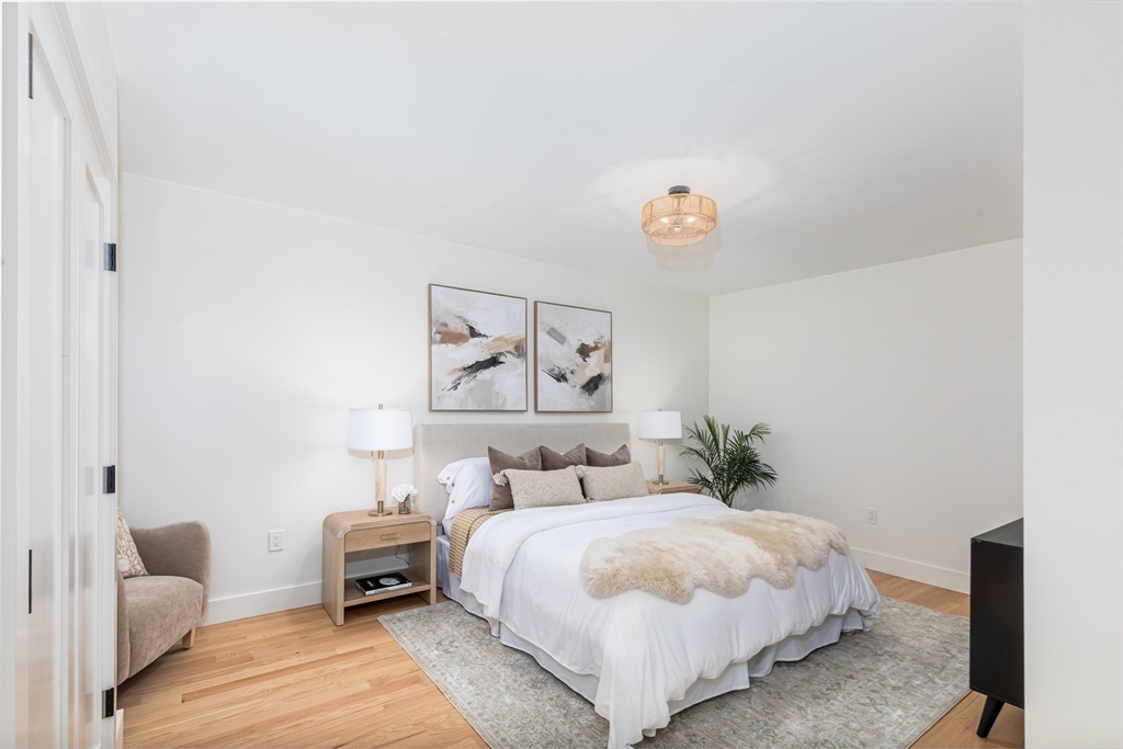 96 Burpee Road, Unit 1 Swampscott, MA 01907 - Photo 10 of 17 a bedroom with a bed and a couch