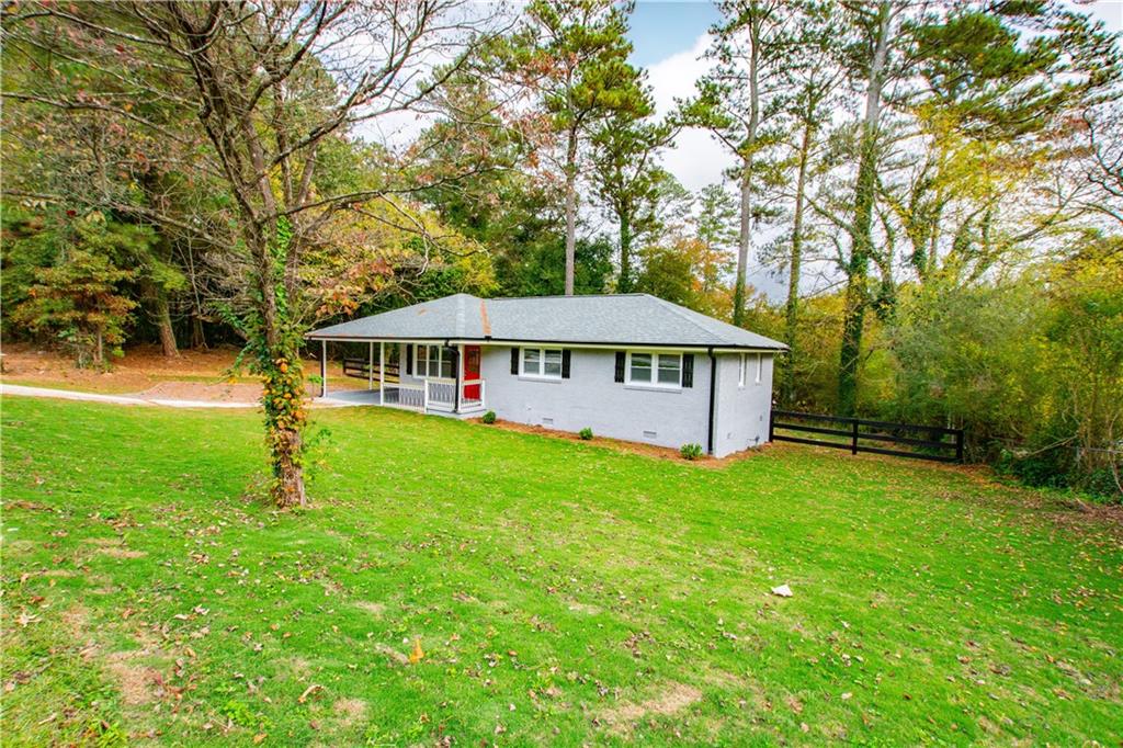 6139 Pisgah Road Southwest Mableton, GA 30126 - Photo 1 of 1 a front view of a house with garden