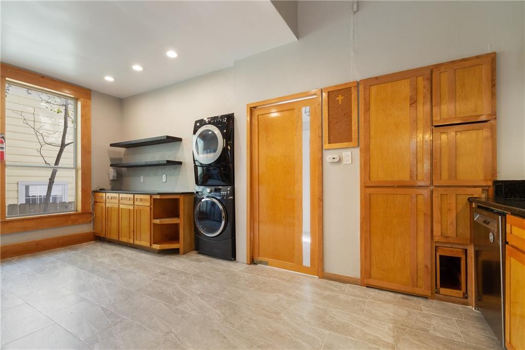 3210 Hampton Road, Unit A Austin, TX 78705 - Photo 6 of 25 Gleaming tile floors and natural wood cabinetry anchor this versatile utility space with outdoor views.