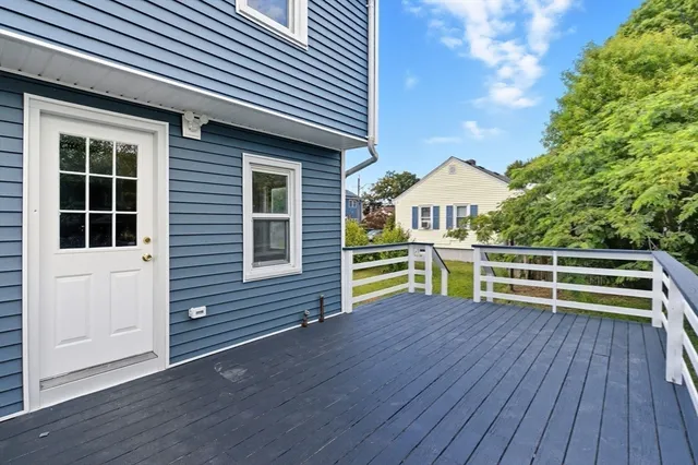 a view of a house with a balcony and wooden floor