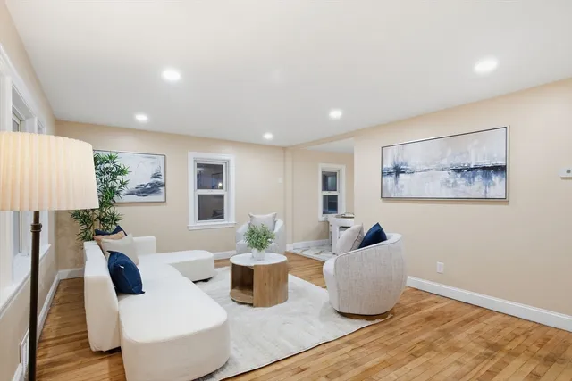 a living room with furniture and flowers