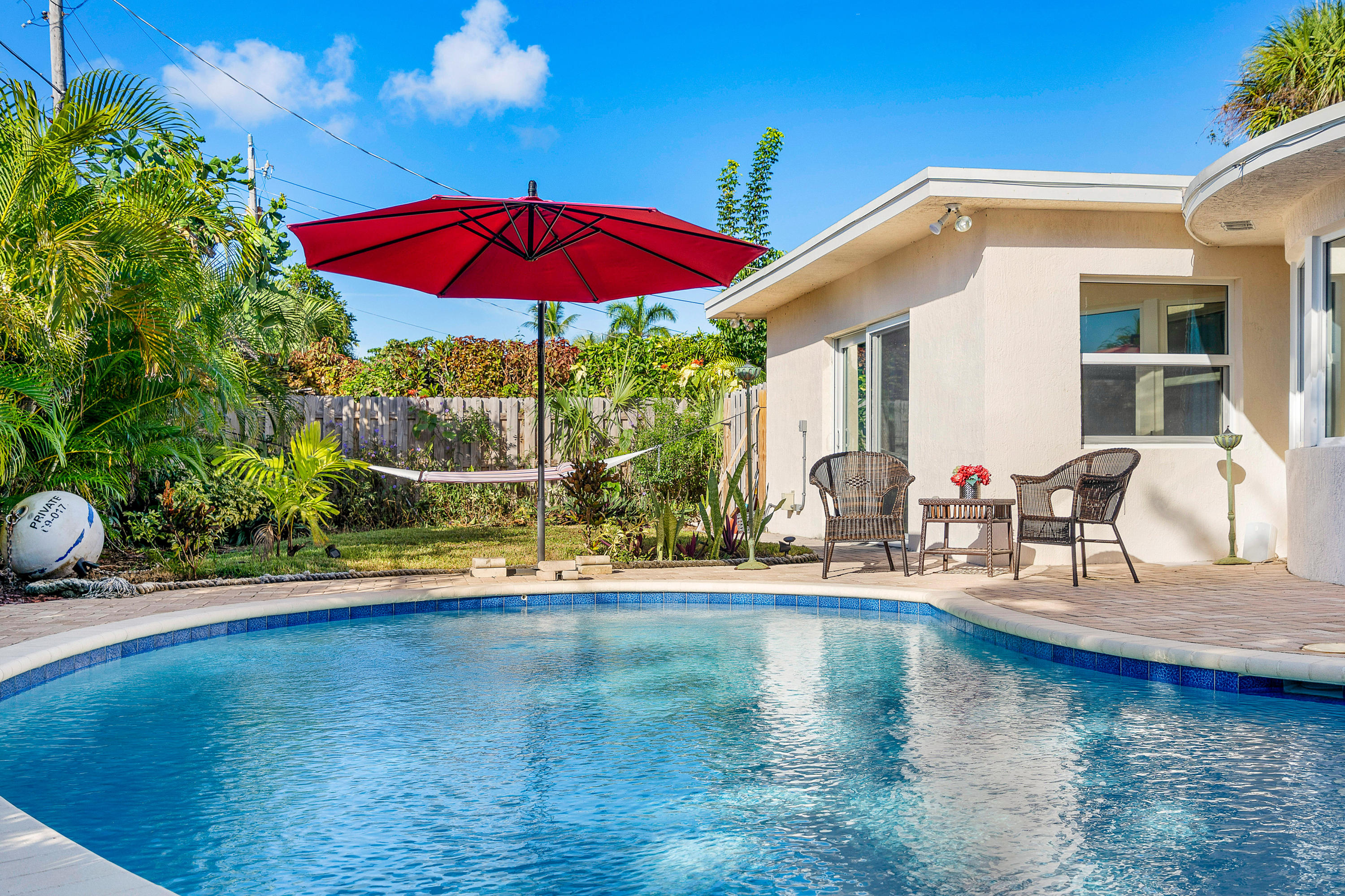 208 Bamboo Road Palm Beach Shores, FL 33404 - Photo 21 of 30 a view of a house with swimming pool and sitting area