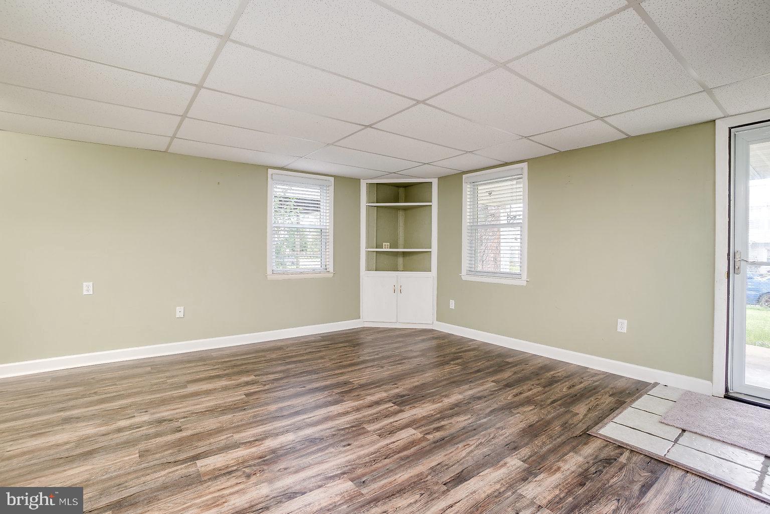 7708 Fairgreen Road Baltimore, MD 21222 - Photo 12 of 44 a view of an empty room with wooden floor and a window