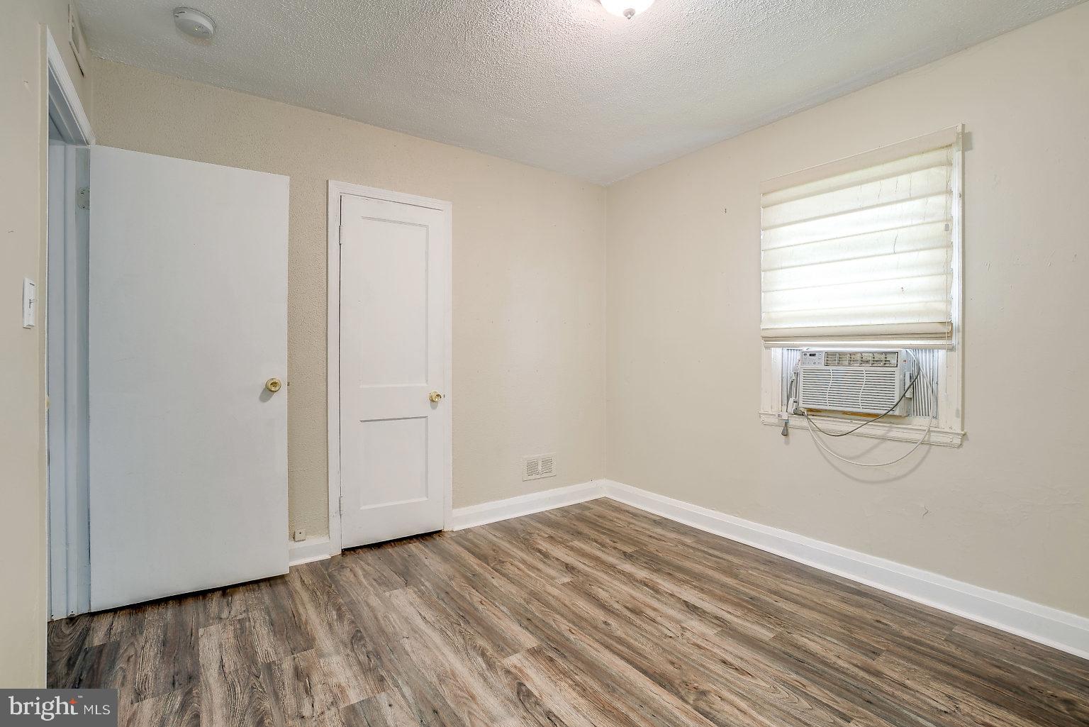 7708 Fairgreen Road Baltimore, MD 21222 - Photo 17 of 44 a view of empty room with wooden floor and fan