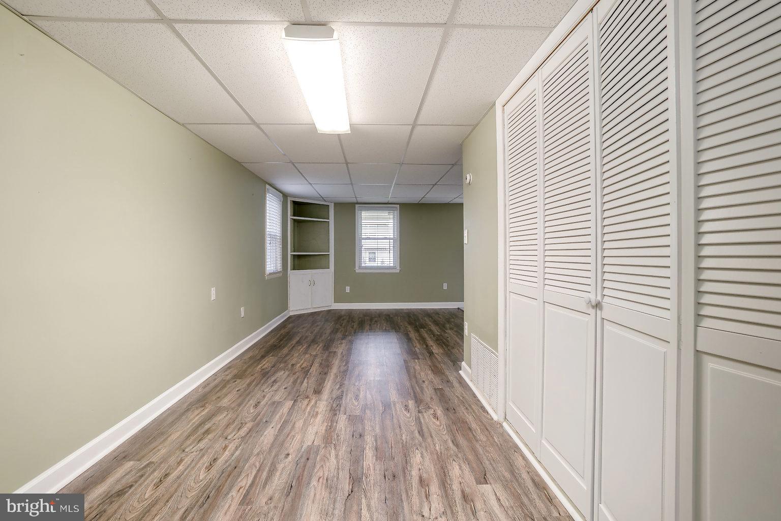 7708 Fairgreen Road Baltimore, MD 21222 - Photo 21 of 44 a view of a hallway with wooden floor and a window