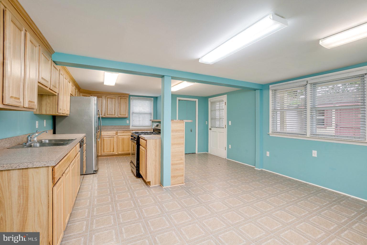 7708 Fairgreen Road Baltimore, MD 21222 - Photo 22 of 44 a kitchen with a refrigerator and a sink