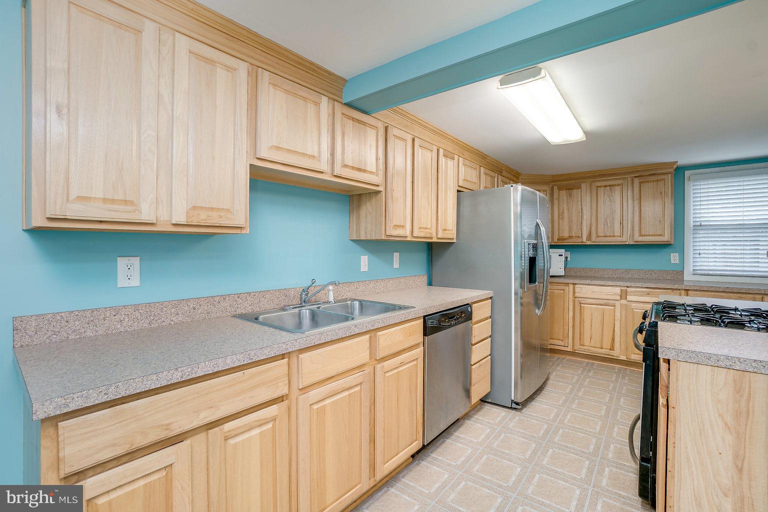 7708 Fairgreen Road Baltimore, MD 21222 - Photo 26 of 44 a kitchen with granite countertop a sink stove and cabinets