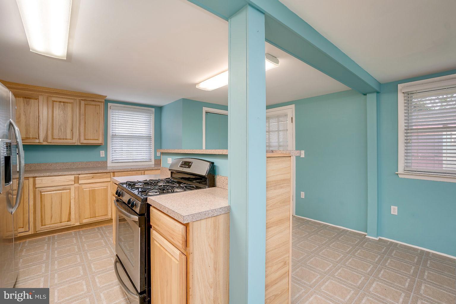 7708 Fairgreen Road Baltimore, MD 21222 - Photo 28 of 44 a kitchen with a stove a sink and a refrigerator