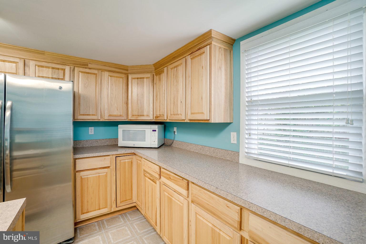 7708 Fairgreen Road Baltimore, MD 21222 - Photo 31 of 44 a kitchen with granite countertop white cabinets and white appliances