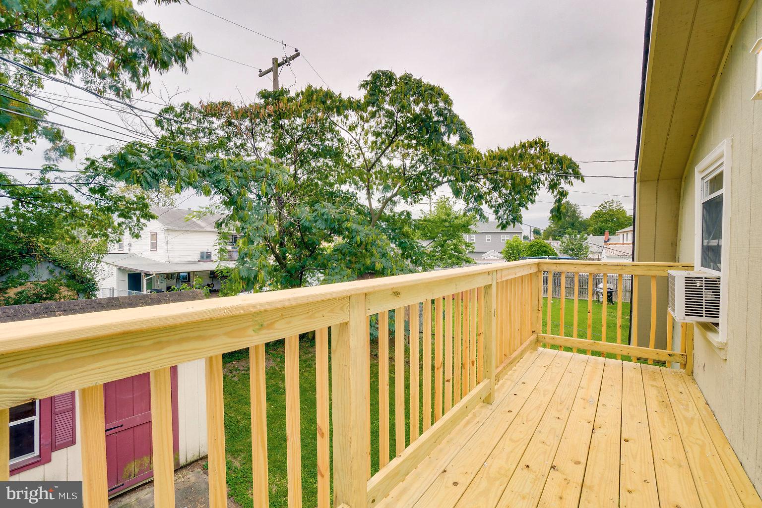 7708 Fairgreen Road Baltimore, MD 21222 - Photo 44 of 44 a balcony with wooden floor and fence