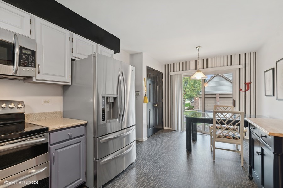 1971 Koehling Road Northbrook, IL 60062 - Photo 8 of 14 a kitchen with stainless steel appliances granite countertop a refrigerator and a stove top oven
