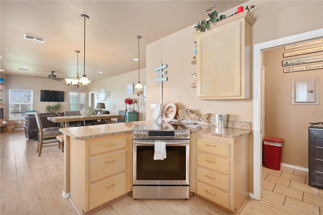 384 Egery Island Road Woodsboro, TX 78393 - Photo 12 of 37 a kitchen that has a lot of white cabinets and stainless steel appliances