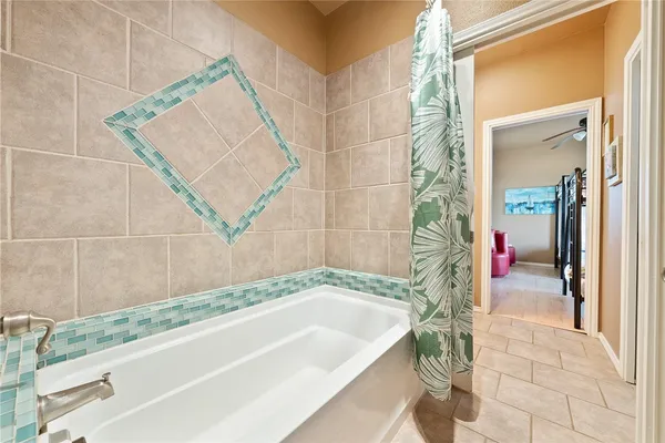 a bathroom with a tub and shower