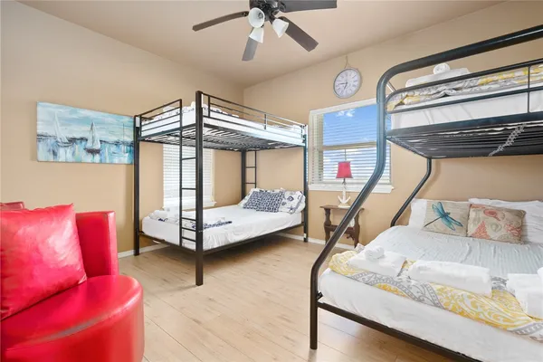 a bedroom with furniture and a large window