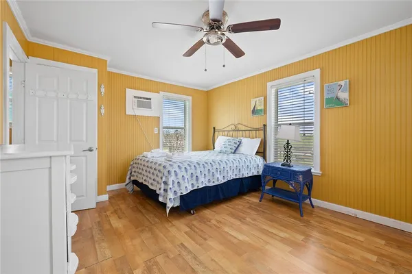 a bedroom with a bed dresser and a window