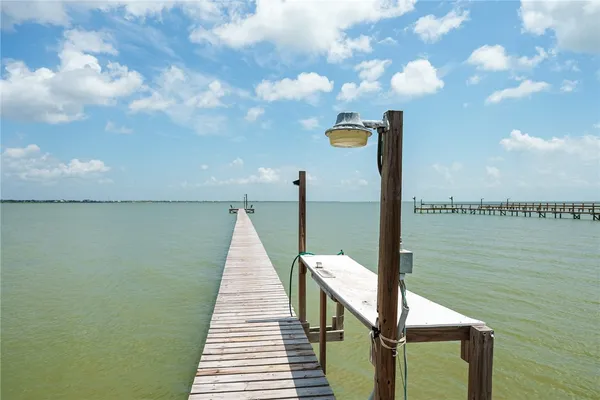 a view of a lake with a bench and a lake in the back
