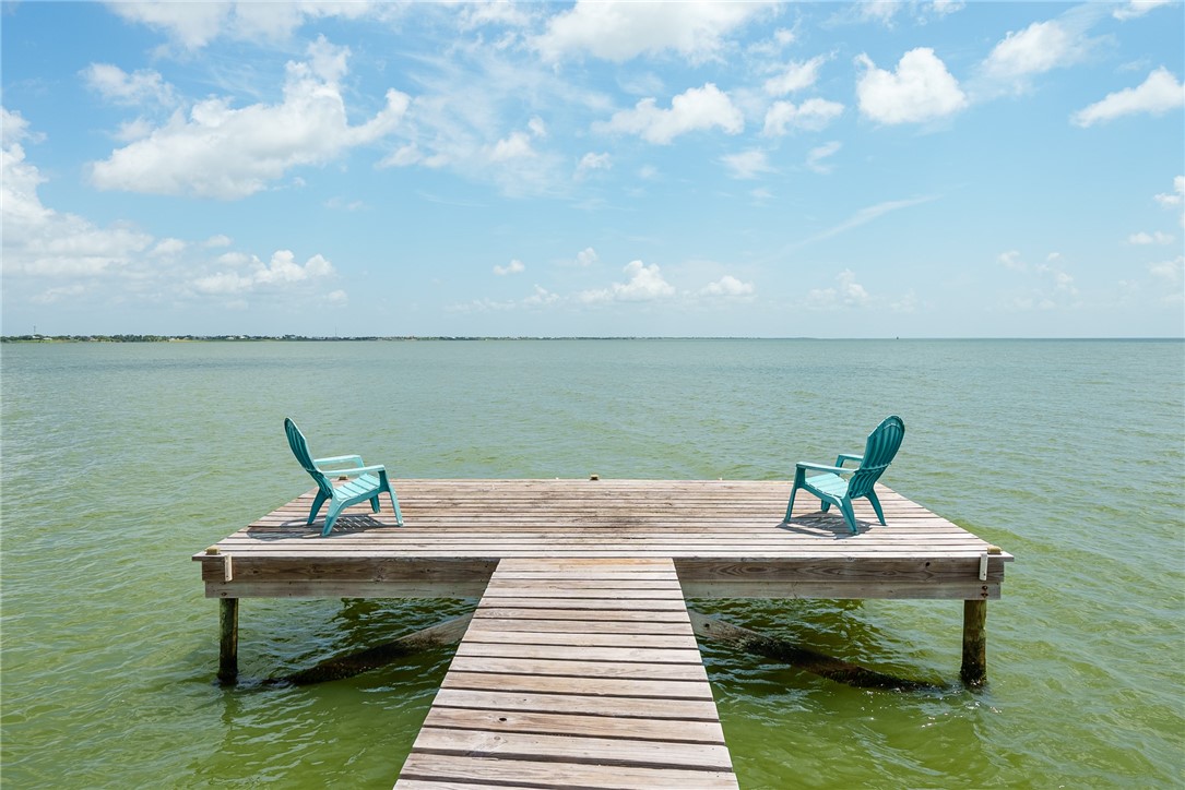 384 Egery Island Road Woodsboro, TX 78393 - Photo 33 of 37 a view of a lake with a bench and a lake in the back