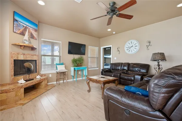 a living room with furniture a fireplace and a flat screen tv