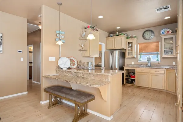 a kitchen with refrigerator cabinets and wooden floor