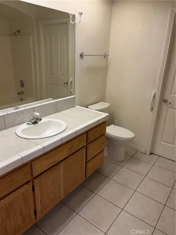 a bathroom with a sink toilet and vanity