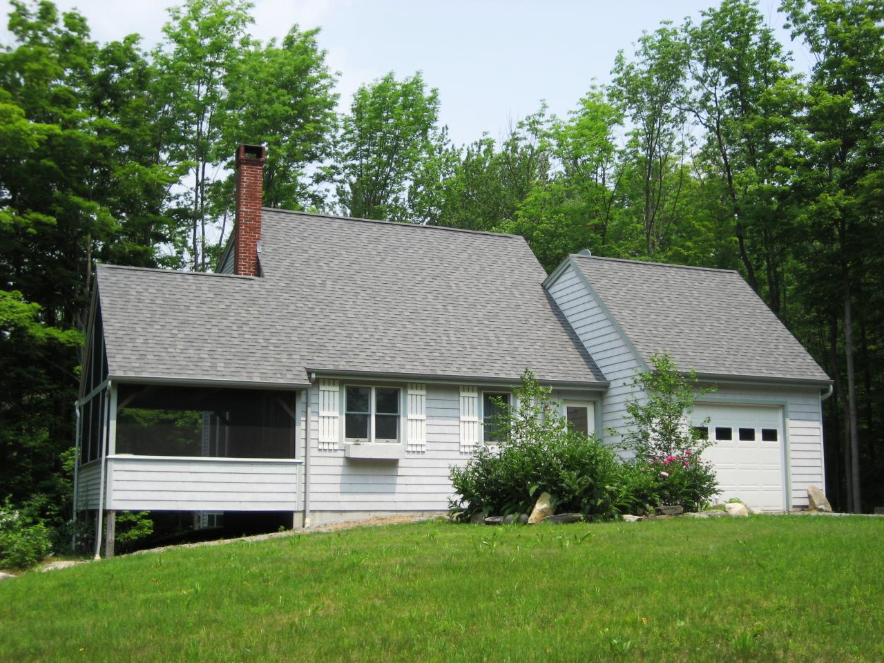 1190 West Center Road Otis, MA 01253 - Photo 1 of 9 a aerial view of a house next to a yard and large trees