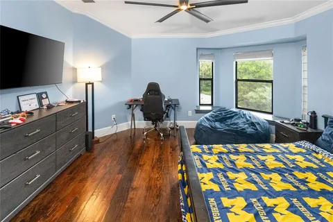 a bed room with a bed and a flat tv screen