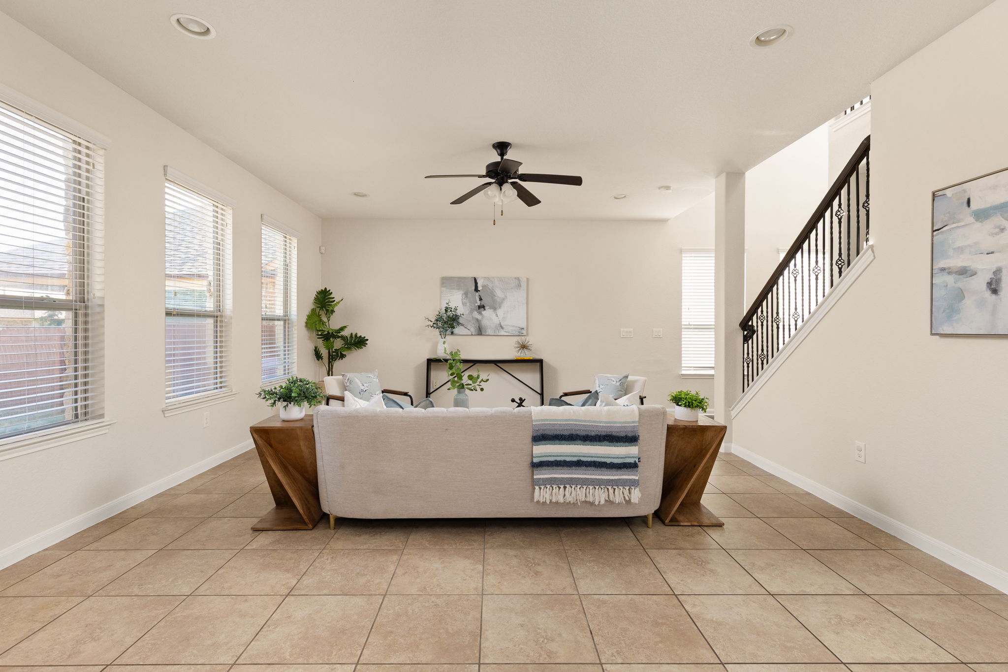 2400 Leonards Pass Leander, TX 78641 - Photo 12 of 40 The inviting living area features warm tile flooring and a grand staircase.