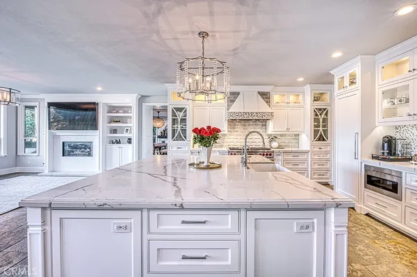 a kitchen with stainless steel appliances granite countertop a sink and cabinets