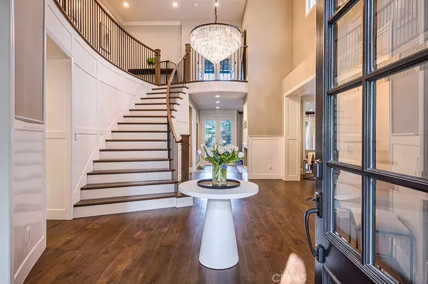 a view of a dining room with furniture wooden floor and a chandelier