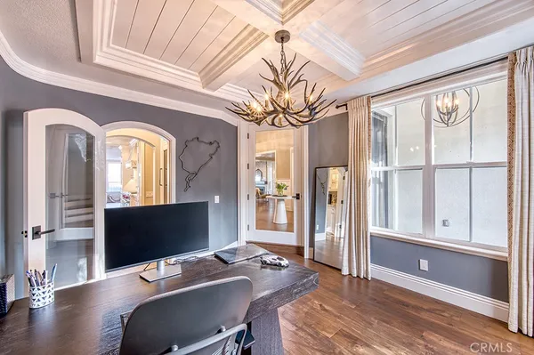 a view of a workspace with furniture window and wooden floor