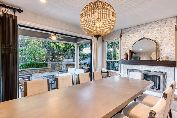 a living room with furniture a table and a large window