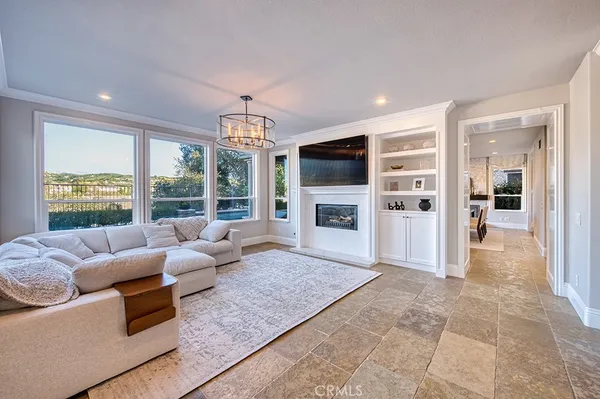a living room with furniture large windows and a flat screen tv