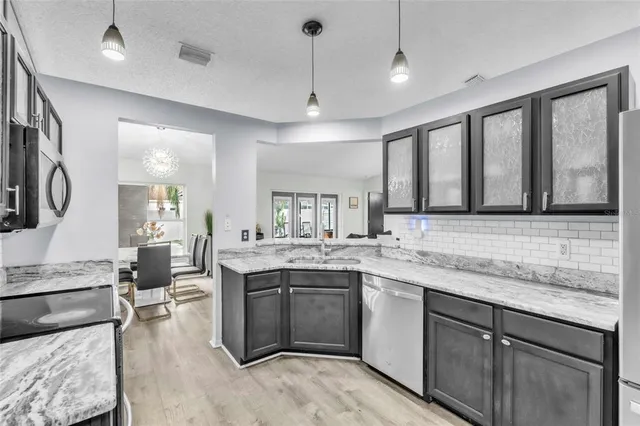 a kitchen with a sink stove and wooden cabinets