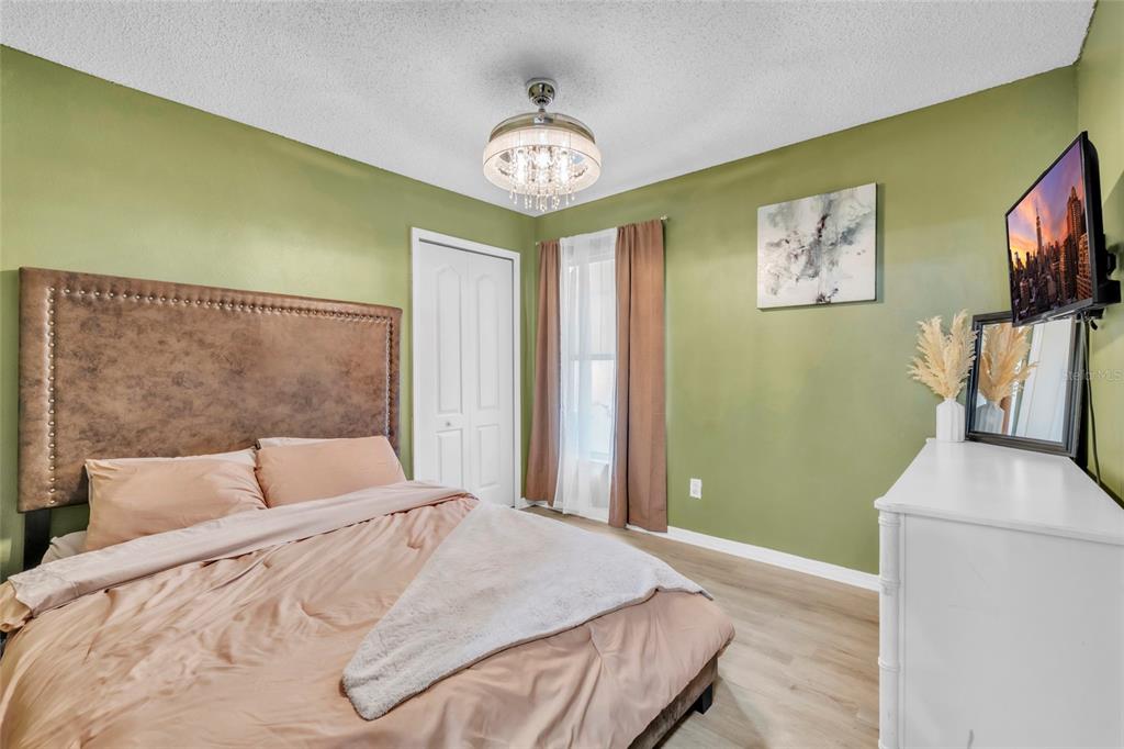 12410 Early Run Lane Riverview, FL 33578 - Photo 15 of 34 a bedroom with a bed and a flat screen tv