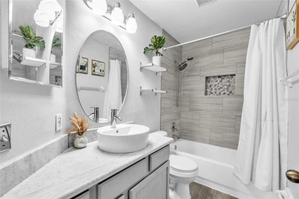 12410 Early Run Lane Riverview, FL 33578 - Photo 16 of 34 a bath room with a toilet a sink and a bath tub