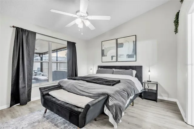 a bedroom with a large bed and a chandelier