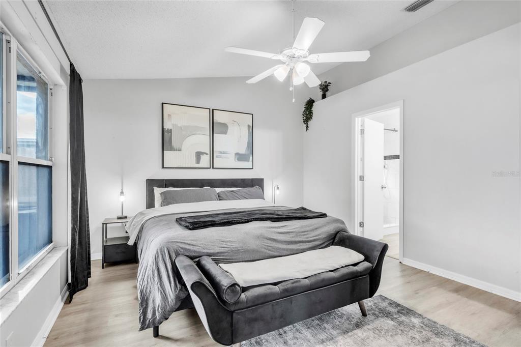 12410 Early Run Lane Riverview, FL 33578 - Photo 18 of 34 a bedroom with a bed and a chandelier