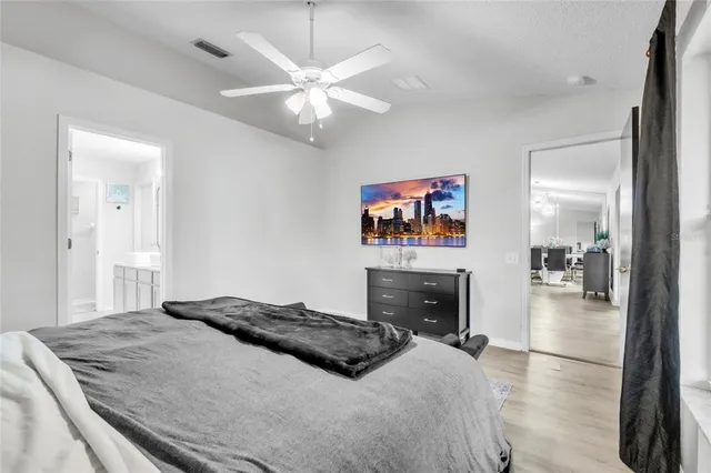 a bedroom with a bed and a chandelier