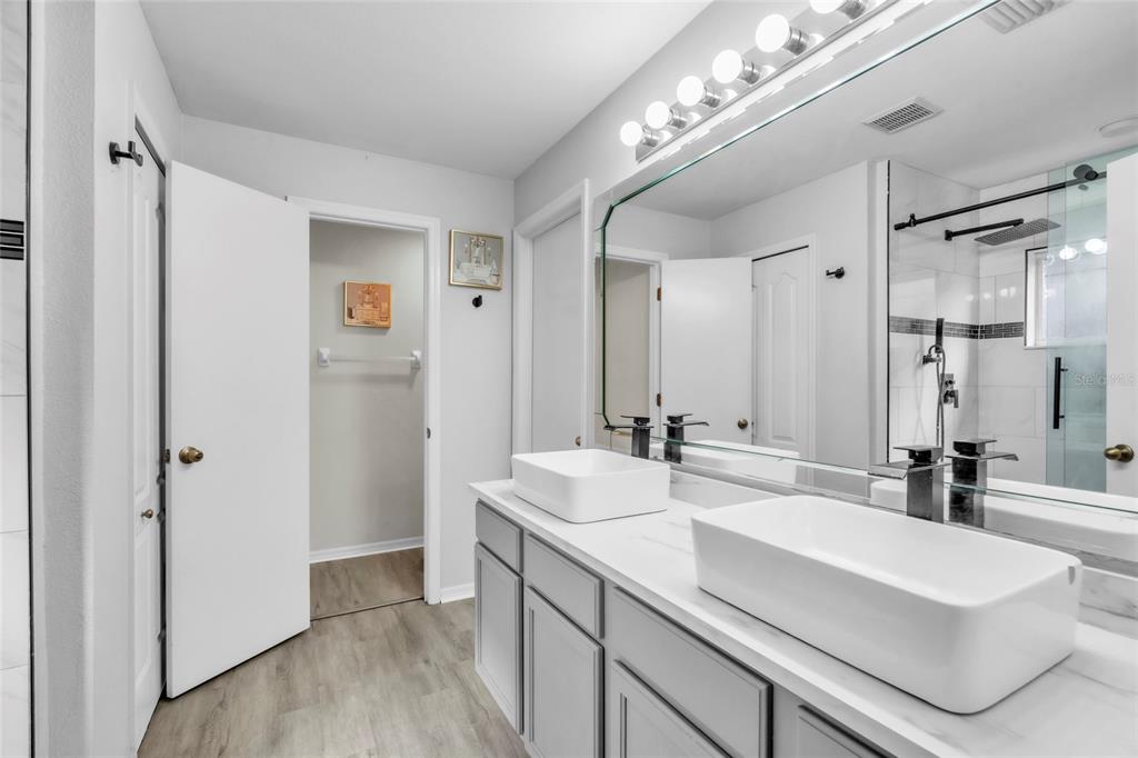 12410 Early Run Lane Riverview, FL 33578 - Photo 20 of 34 a bathroom with double vanity and a mirror