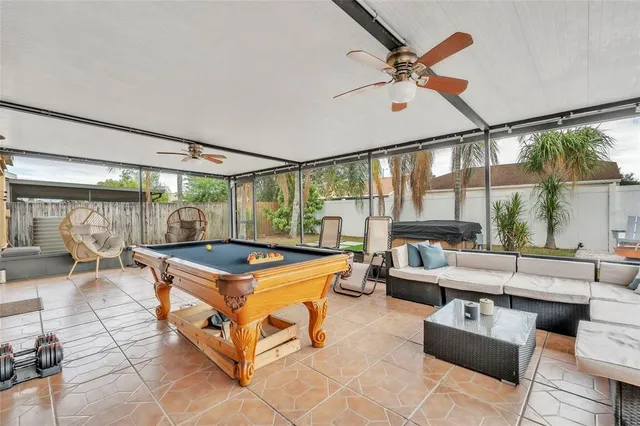 a living room with furniture a table and a large window