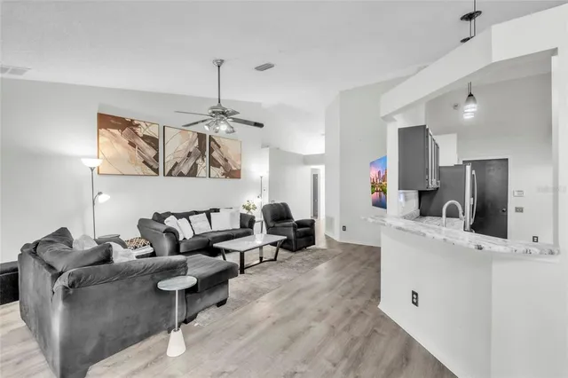 a living room with furniture and a chandelier