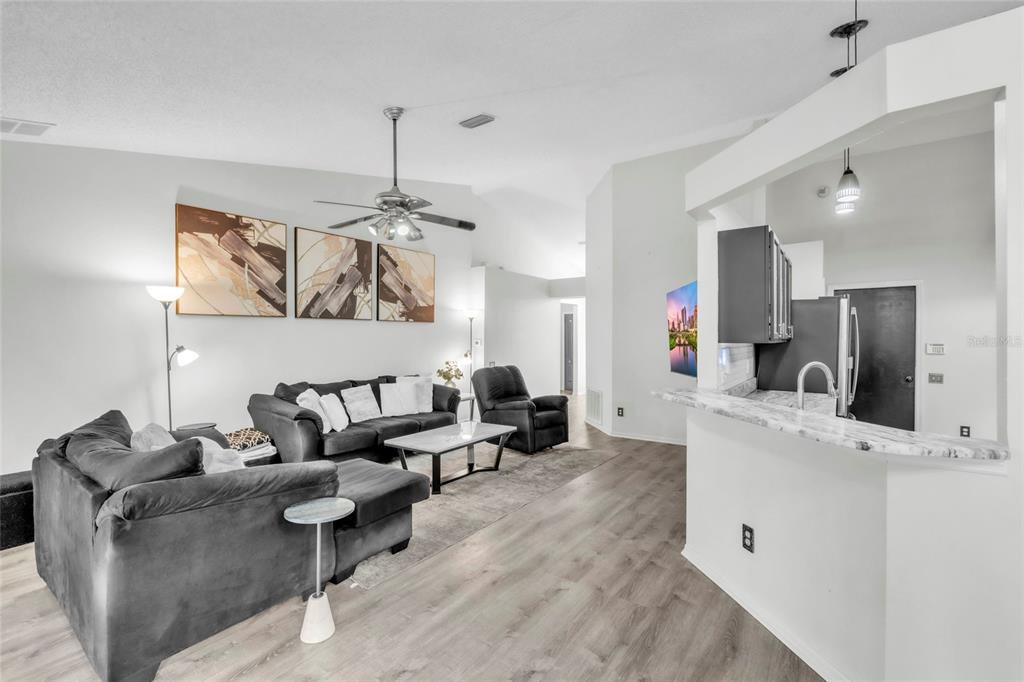 12410 Early Run Lane Riverview, FL 33578 - Photo 4 of 34 a living room with furniture and a chandelier