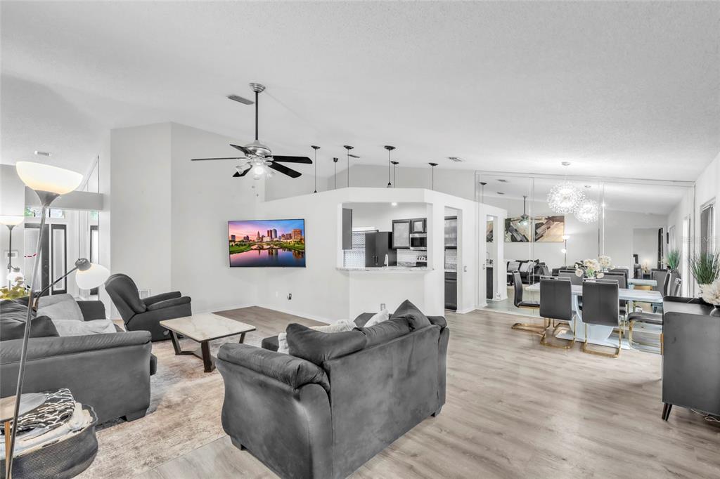 12410 Early Run Lane Riverview, FL 33578 - Photo 5 of 34 a living room with furniture kitchen view and a chandelier